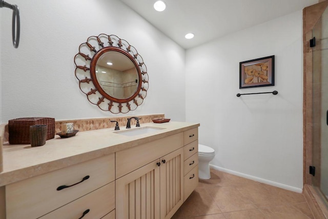 bathroom featuring toilet, tile patterned floors, an enclosed shower, and vanity