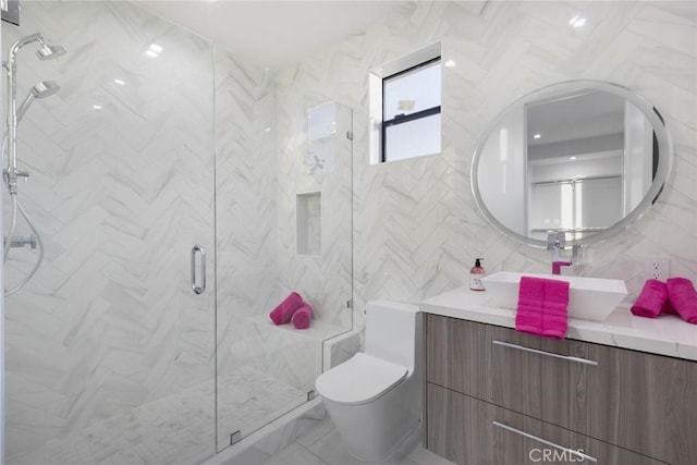 bathroom with toilet, an enclosed shower, tile walls, and vanity