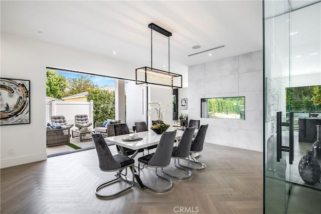 dining space featuring parquet floors