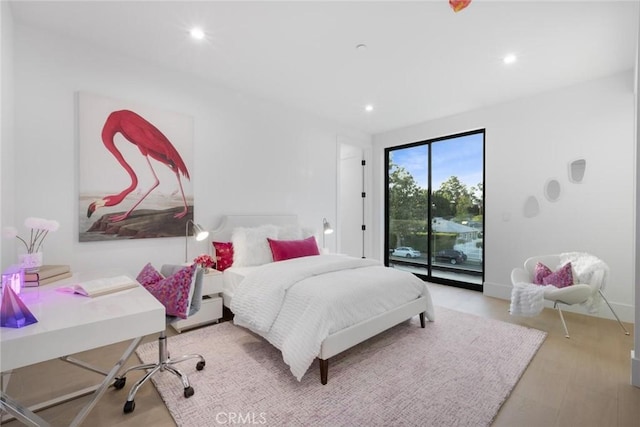 bedroom with light hardwood / wood-style flooring and access to exterior