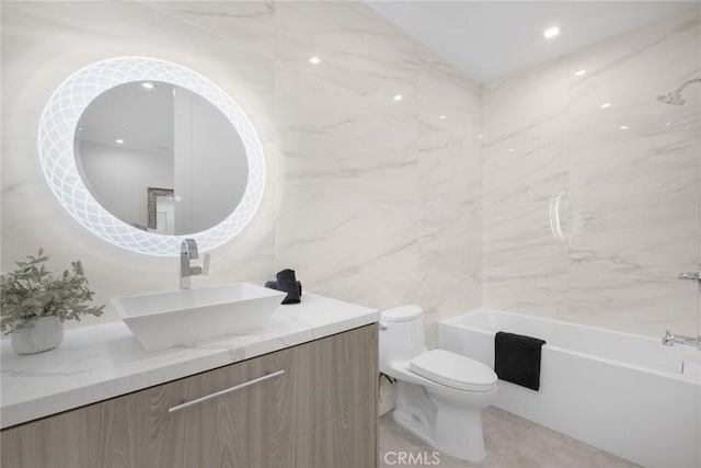 full bathroom featuring toilet, shower / bathing tub combination, tile walls, and vanity