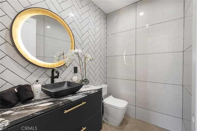 bathroom with toilet, vanity, and parquet floors