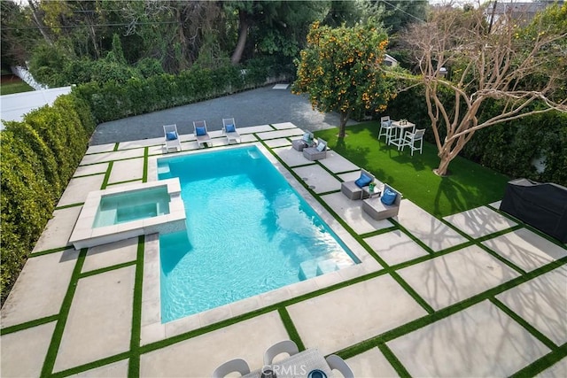 view of swimming pool with a lawn, a patio area, and an in ground hot tub