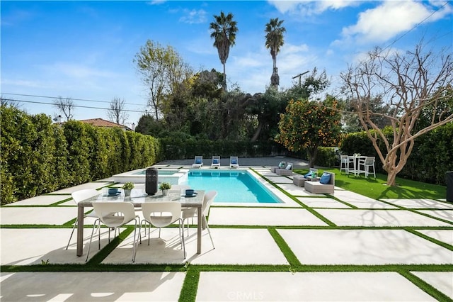 view of swimming pool with a patio area