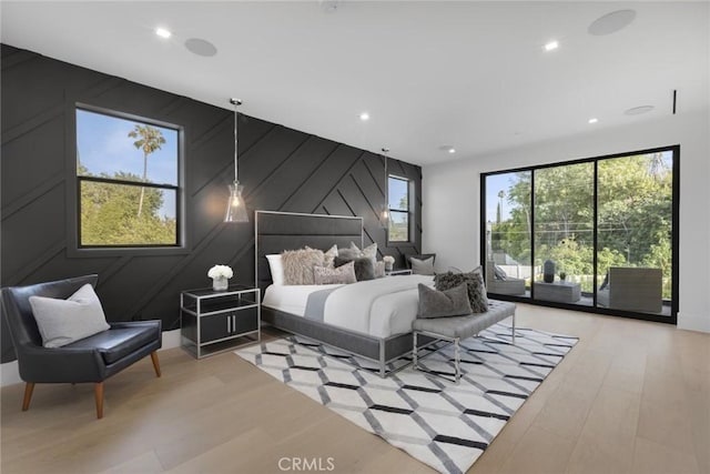 bedroom with light wood-type flooring and access to outside