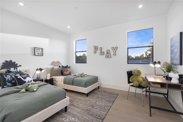 bedroom featuring lofted ceiling and hardwood / wood-style floors