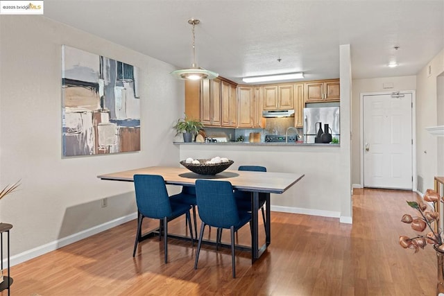 dining space with hardwood / wood-style flooring