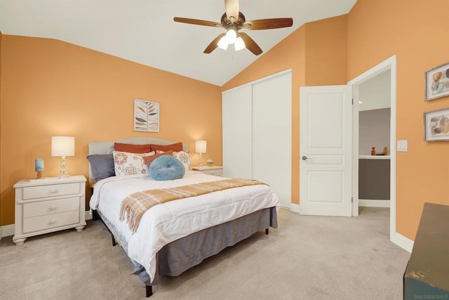 carpeted bedroom with vaulted ceiling, ceiling fan, and a closet