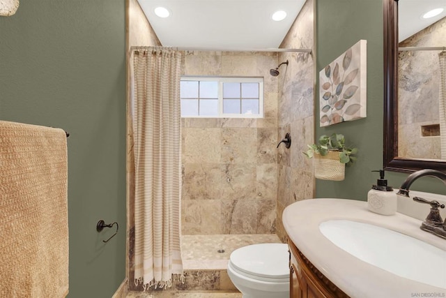 bathroom with toilet, vanity, and curtained shower