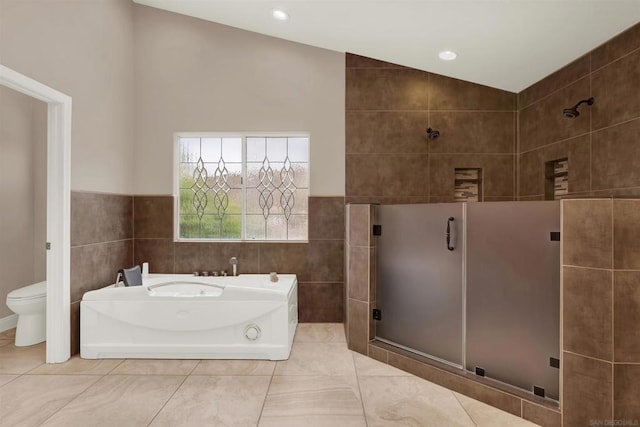 bathroom featuring toilet, lofted ceiling, tile patterned floors, tile walls, and shower with separate bathtub