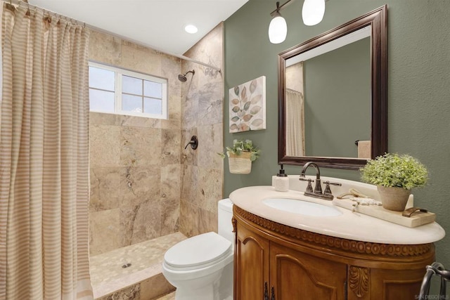 bathroom featuring toilet, vanity, and a shower with shower curtain