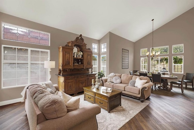 living room featuring a high ceiling, dark hardwood / wood-style floors, and a chandelier