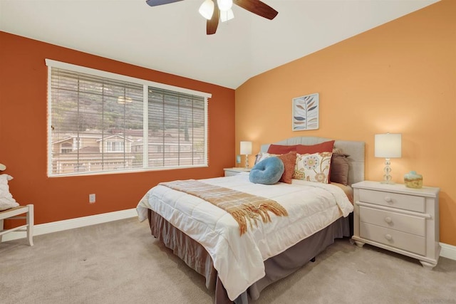 bedroom with ceiling fan, lofted ceiling, and light colored carpet