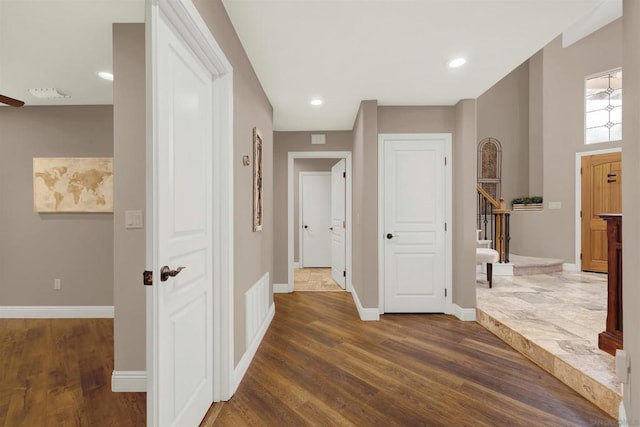 hallway with dark hardwood / wood-style flooring