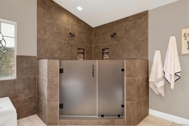 bathroom featuring walk in shower and lofted ceiling