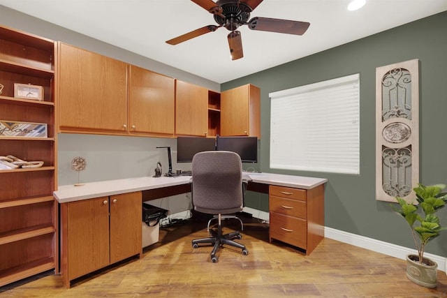 office with ceiling fan, light hardwood / wood-style floors, and built in desk