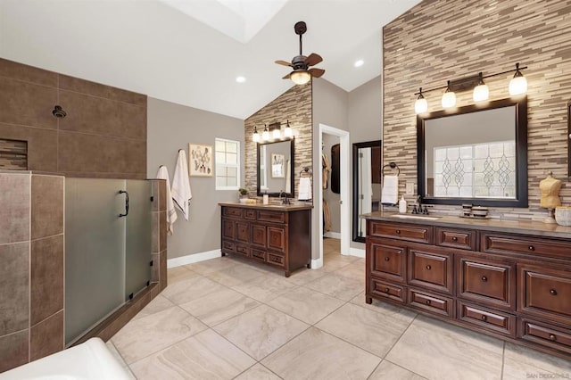 bathroom featuring ceiling fan, plenty of natural light, vanity, and high vaulted ceiling