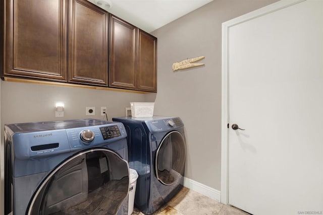 washroom with cabinets, light tile patterned floors, and independent washer and dryer