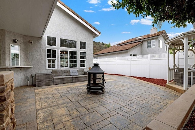 view of patio / terrace with an outdoor living space with a fire pit