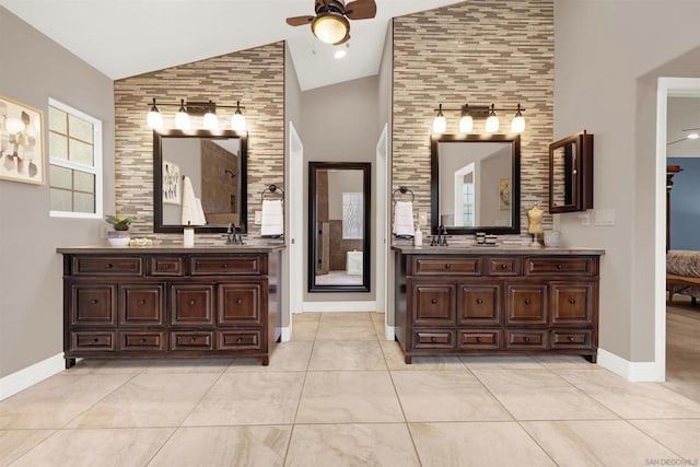 bathroom with ceiling fan, high vaulted ceiling, and vanity