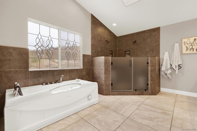 bathroom featuring vaulted ceiling and independent shower and bath