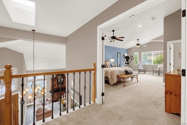 bedroom featuring light carpet, a notable chandelier, and vaulted ceiling