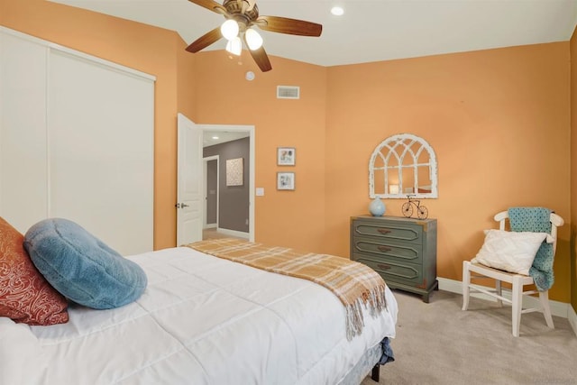 bedroom with ceiling fan, light colored carpet, and vaulted ceiling