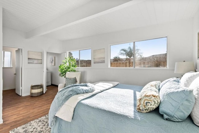 bedroom featuring beamed ceiling and wood-type flooring