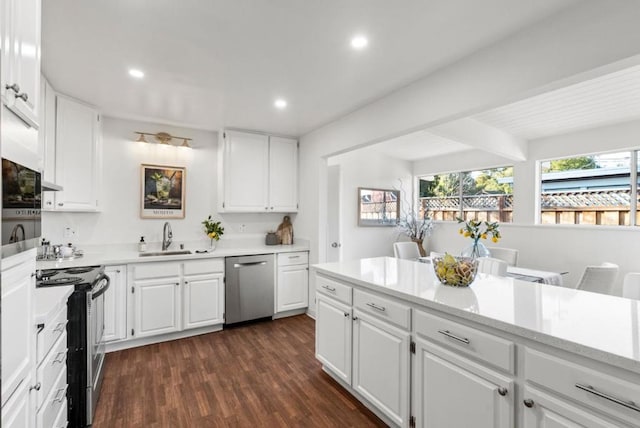 kitchen with sink, white cabinetry, stainless steel appliances, dark hardwood / wood-style floors, and light stone countertops