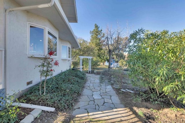 view of side of home with a pergola