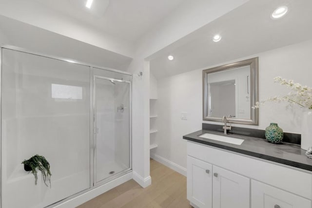 bathroom featuring vanity, hardwood / wood-style floors, and an enclosed shower