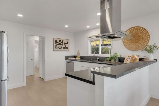 kitchen featuring refrigerator, sink, island exhaust hood, kitchen peninsula, and light wood-type flooring