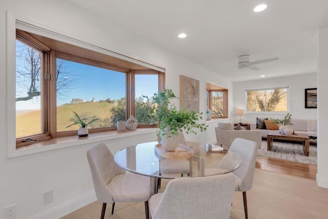 dining area featuring ceiling fan and light hardwood / wood-style flooring