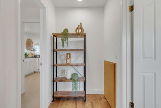 corridor with light hardwood / wood-style floors