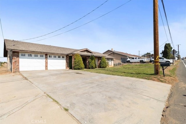 ranch-style house with an attached garage, driveway, brick siding, and a front yard