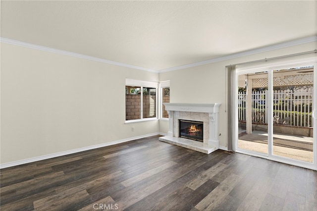 unfurnished living room featuring dark wood-type flooring, a high end fireplace, and crown molding