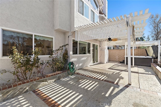 view of patio featuring a pergola, a hot tub, and ceiling fan