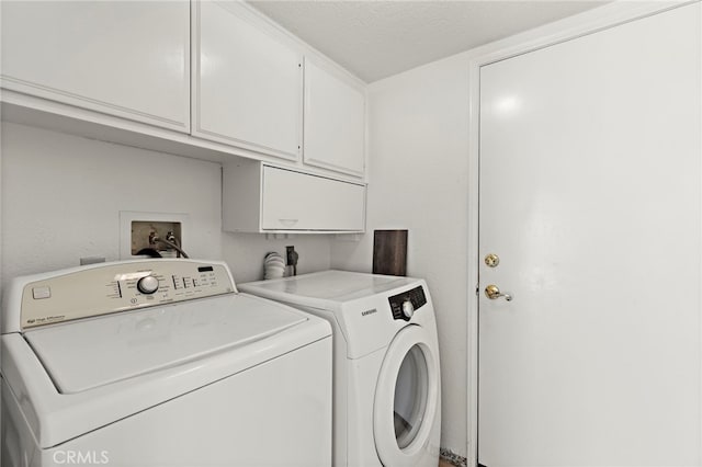 clothes washing area with independent washer and dryer and cabinets