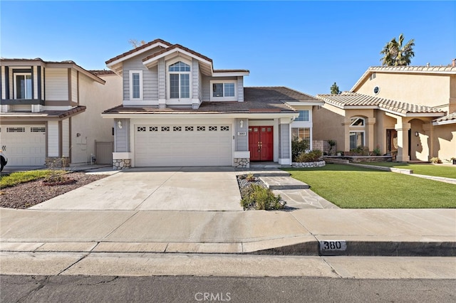 view of front of property with a garage and a front lawn