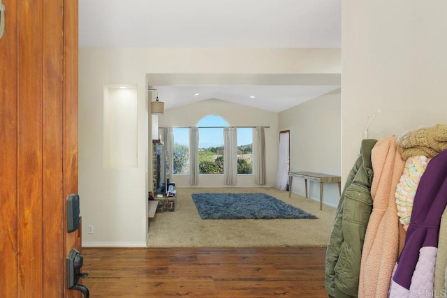 entryway with vaulted ceiling and dark hardwood / wood-style floors