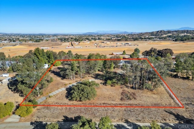 drone / aerial view featuring a mountain view and a rural view