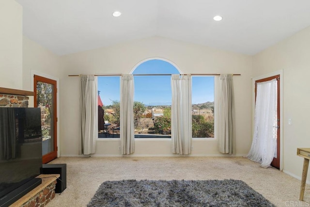 living room featuring light carpet and vaulted ceiling