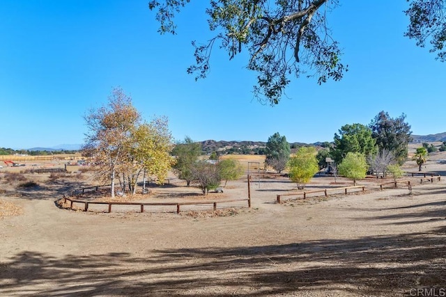 view of yard featuring a rural view and a mountain view