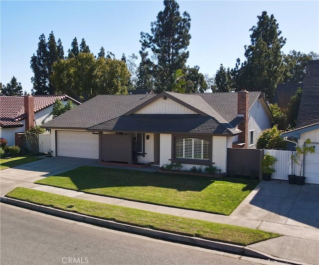 view of front of property featuring a front yard and a garage