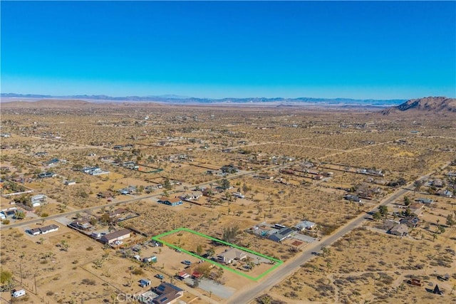 birds eye view of property featuring a mountain view