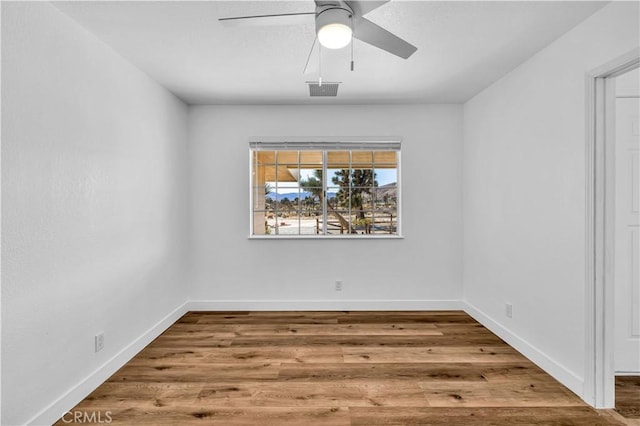 empty room featuring hardwood / wood-style floors and ceiling fan