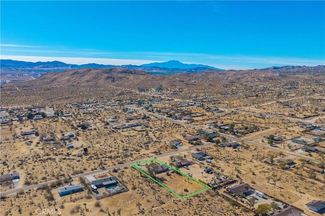 birds eye view of property with a mountain view