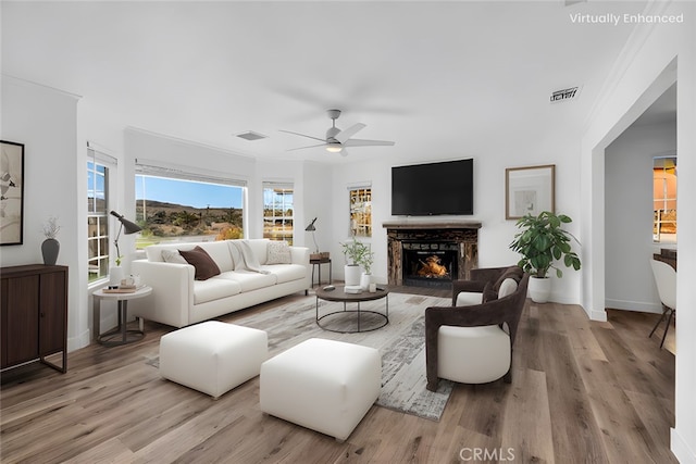 living room with ceiling fan and light hardwood / wood-style flooring