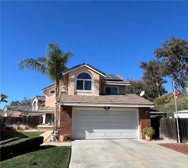 view of front property featuring a garage and solar panels