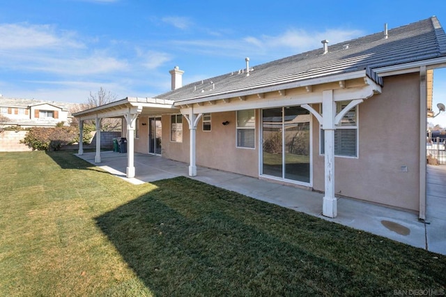 rear view of property with a patio area and a yard